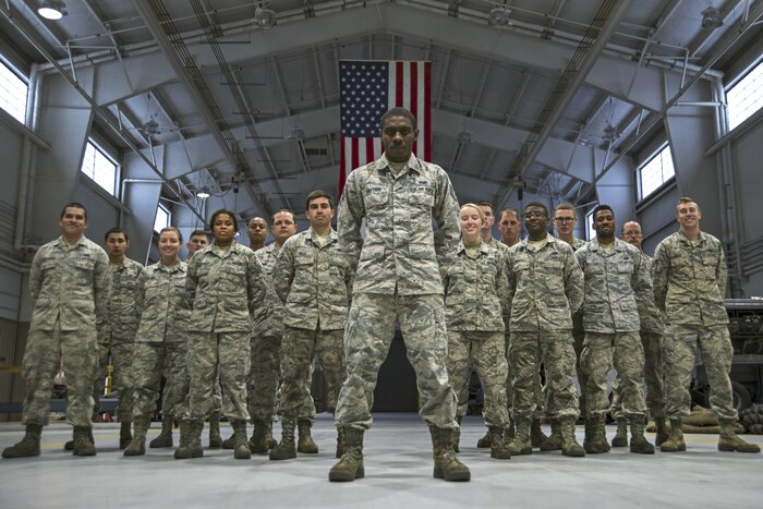 Air Force Staff Sgt. Preston Moten, an aerospace ground equipment schedule and training monitor with the 20th Equipment Maintenance Squadron, stands in front of 20th EMS airmen at Shaw Air Force Base, S.C., Dec. 9, 2016. Moten retained negative habits from his life before the Air Force that jeopardized his career and the safety of his fellow airmen, but with the support and guidance offered by his team members he broke those habits. Air Force photo by Airman 1st Class Kathryn R.C. Reaves