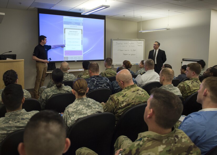 Adam Buckley, left, HC Standard customer service engineer, and Stan Kuzia, HC Standard managing director, instruct a classroom of military medical personnel on how to use HC Standard at the Fort Belvoir Community Hospital in Fort Belvoir, Va., Jan. 13, 2017. The mobile healthcare medical triage and tracking system is a new application that will be used by military and civilian first responders for the 58th Presidential Inauguration to collect medical information and create a common operating picture. (U.S. Air Force photo by Senior Airman Philip Bryant)