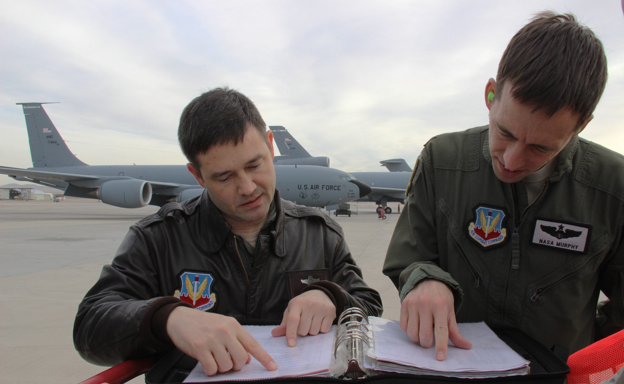 Lt. Col. John Kelley, 509th Weapons Squadron commander, and Maj. Douglas Murphy, 509th WPS KC-135 Stratotanker instructor pilot, review flight plans on the Nellis Air Force Base flight line Dec. 14, 2016. The 509th WPS, part of the U.S. Air Force Weapons School, flies aerial refueling missions during all of the Weapons School’s integration phases. (U.S. Air Force Photo Susan Garcia) 