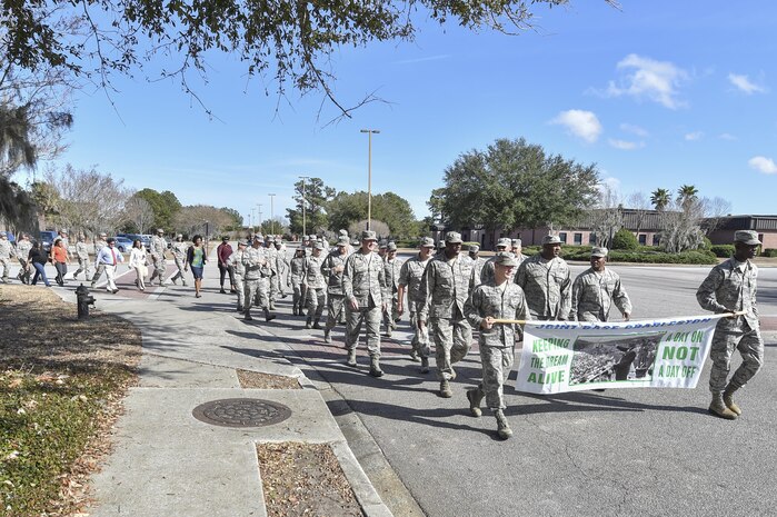 Members of Joint Base Charleston march during the Dr. Martin Luther King Jr. remembrance event at the Air Base Chapel Jan. 17, 2017 at Joint Base Charleston, South Carolina. The ceremony included a march across the base, guest speaker Melvin D. Willis, Space and Naval Warfare Systems Center – Atlantic Enterprise Information Systems Business manager, who spoke about King’s legacy, and a reciting of one of King’s speeches by a local middle school student. 