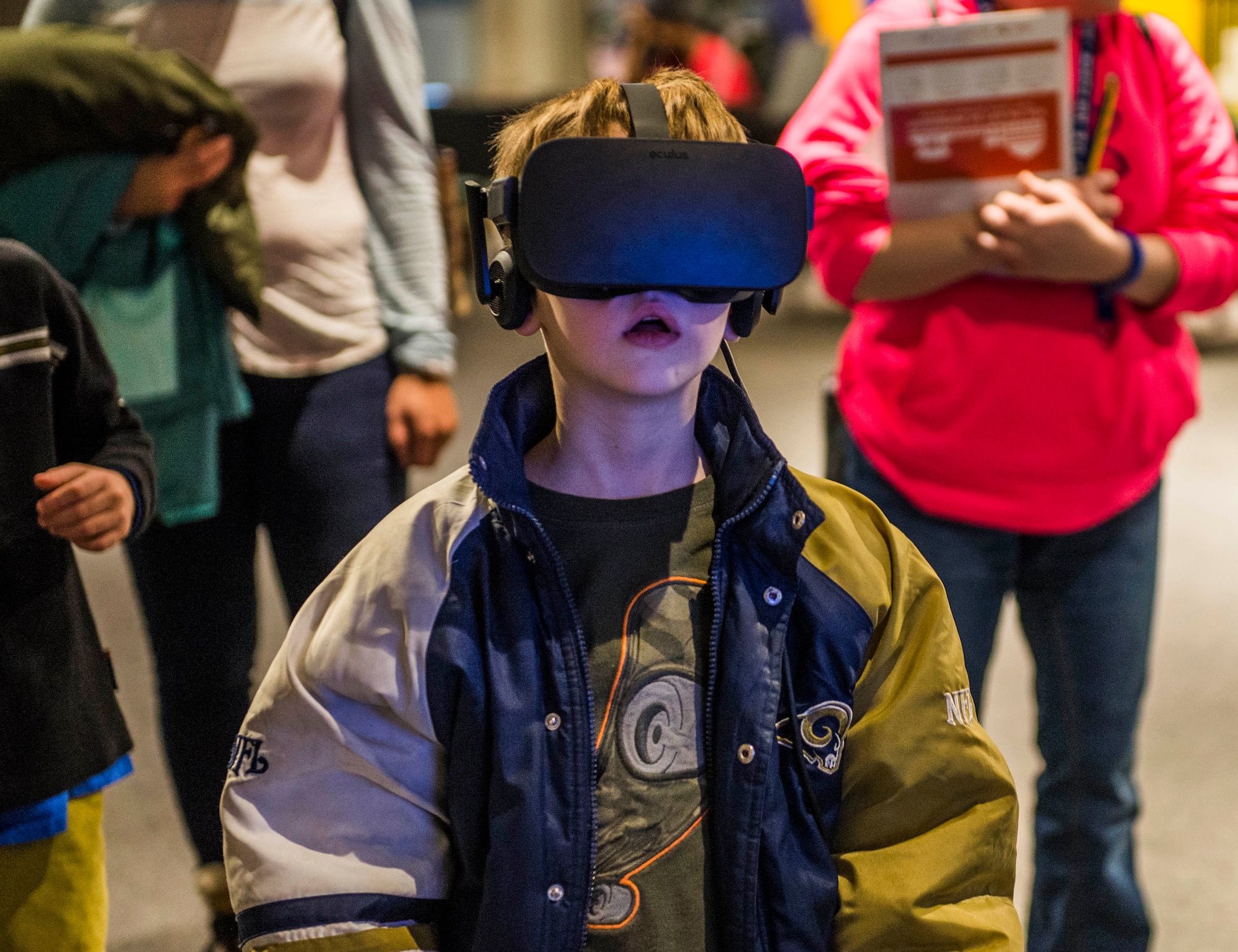A child reacts while having a virtual reality experience at the Air Force booth.  (U.S. Air Force photo by Staff Sgt. Jodi Martinez)