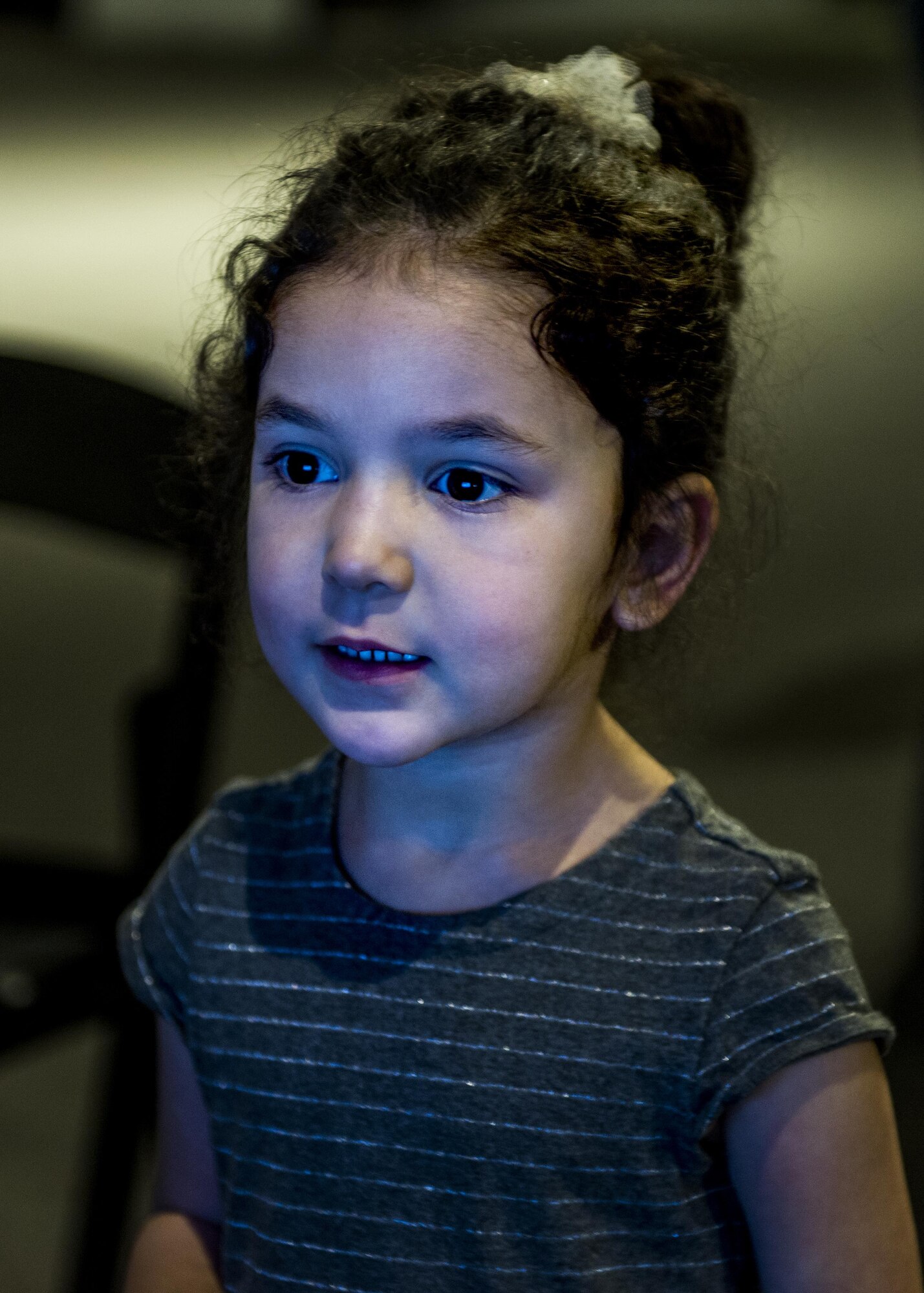 A young girl looks at the virtual reality screen to decide which experience she would like to have.  (U.S. Air Force photo by Staff Sgt. Jodi Martinez)
