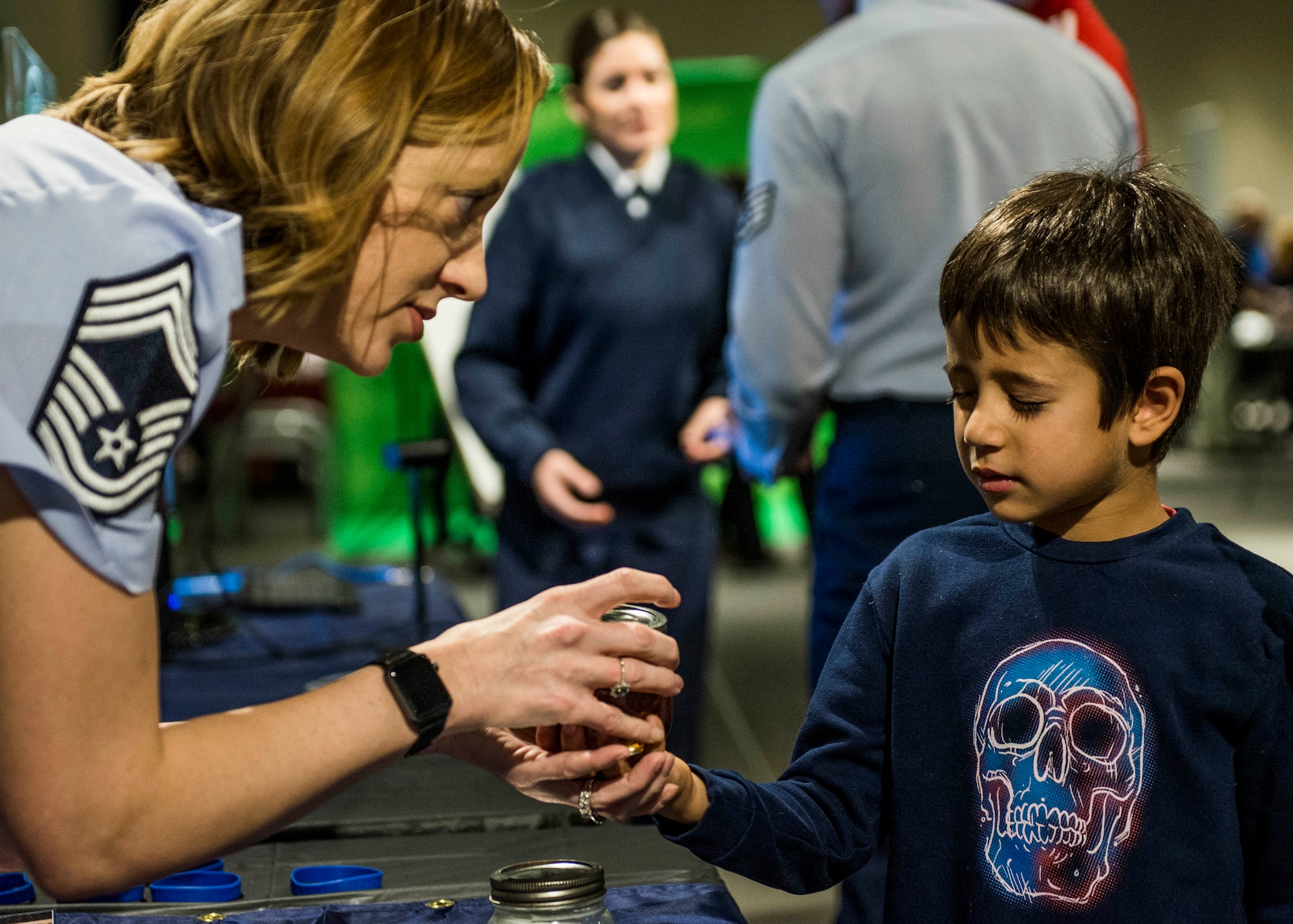 Chief Master Sgt. Diane Slazinik, 375th Communications Group superintendent, asks a visitor to close their eyes for an experiment that shows the effects of acid on teeth. (U.S. Air Force photo by Staff Sgt. Jodi Martinez)