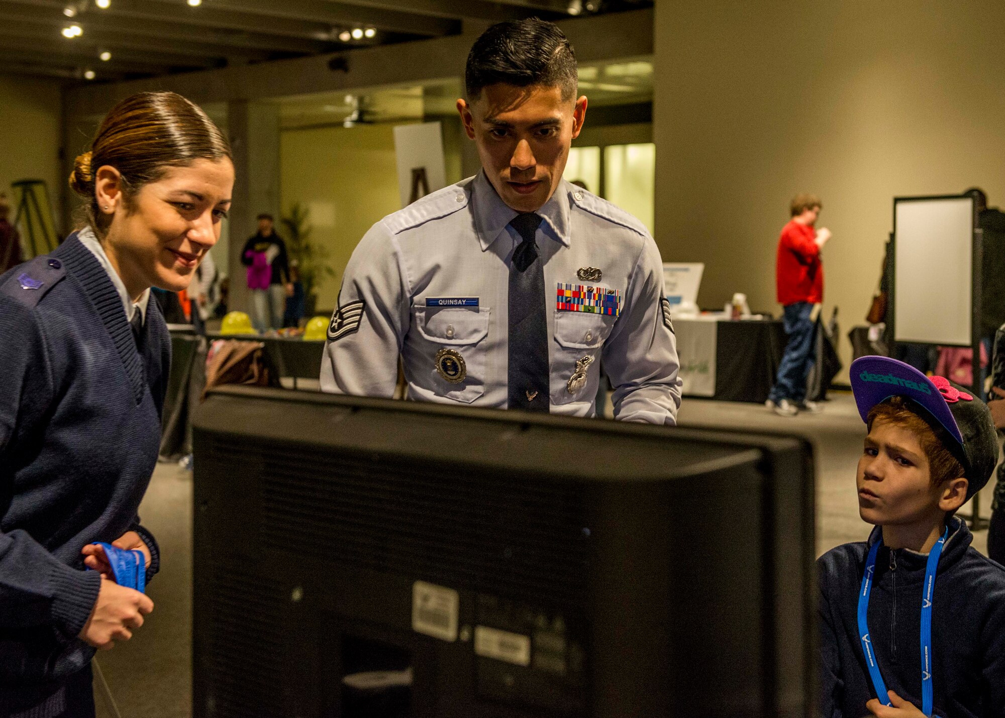 Staff Sgt. Merissa Hunnicut, 345th Recruiting Squadron recruiter, and Staff Sgt. Charles Quinsay, prepare a system for a virtual reality experience during the event.  (U.S. Air Force photo by Staff Sgt. Jodi Martinez)