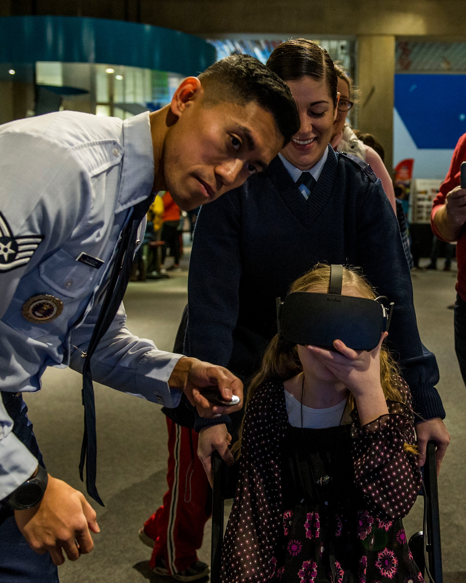 Staff Sgt. Merissa Hunnicut, 345th Recruiting Squadron recruiter, and Staff Sgt. Charles Quinsay, prepare a system for a virtual reality experience during the event.  (U.S. Air Force photo by Staff Sgt. Jodi Martinez)
