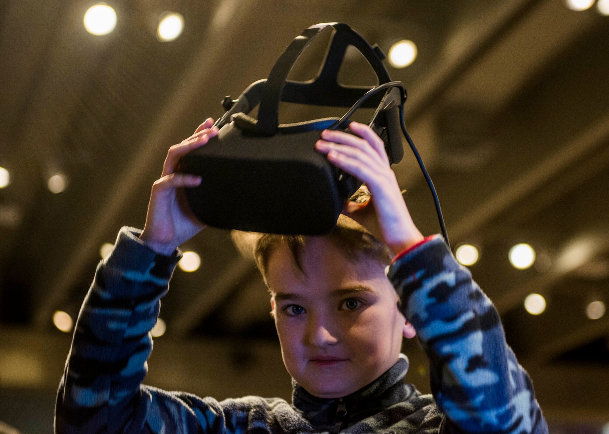 A child experiences a virtual reality scenario during the event. (U.S. Air Force photo by Staff Sgt. Jodi Martinez)