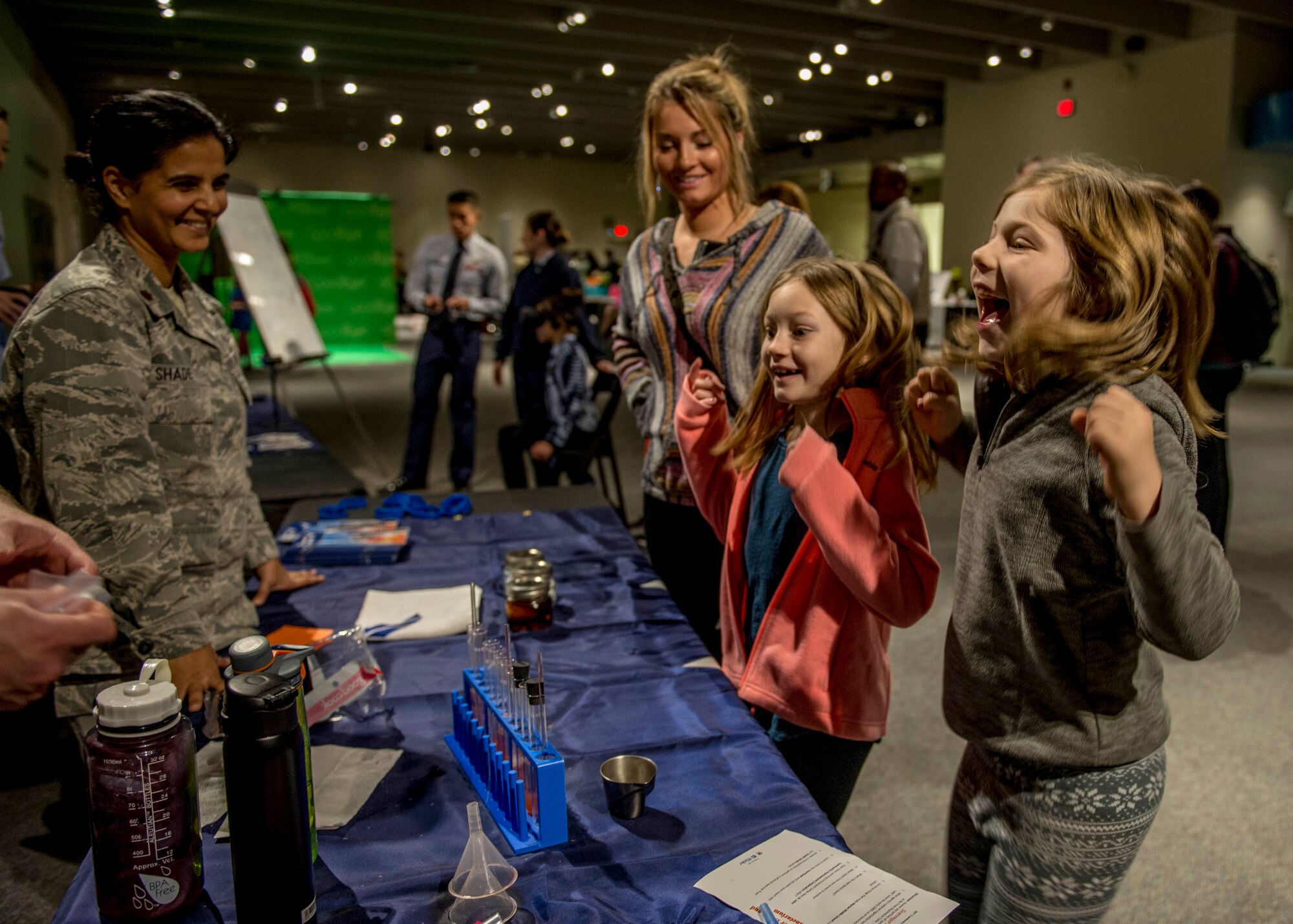 Girls react to learning about the effects of acid on teeth. (U.S. Air Force photo by Staff Sgt. Jodi Martinez)