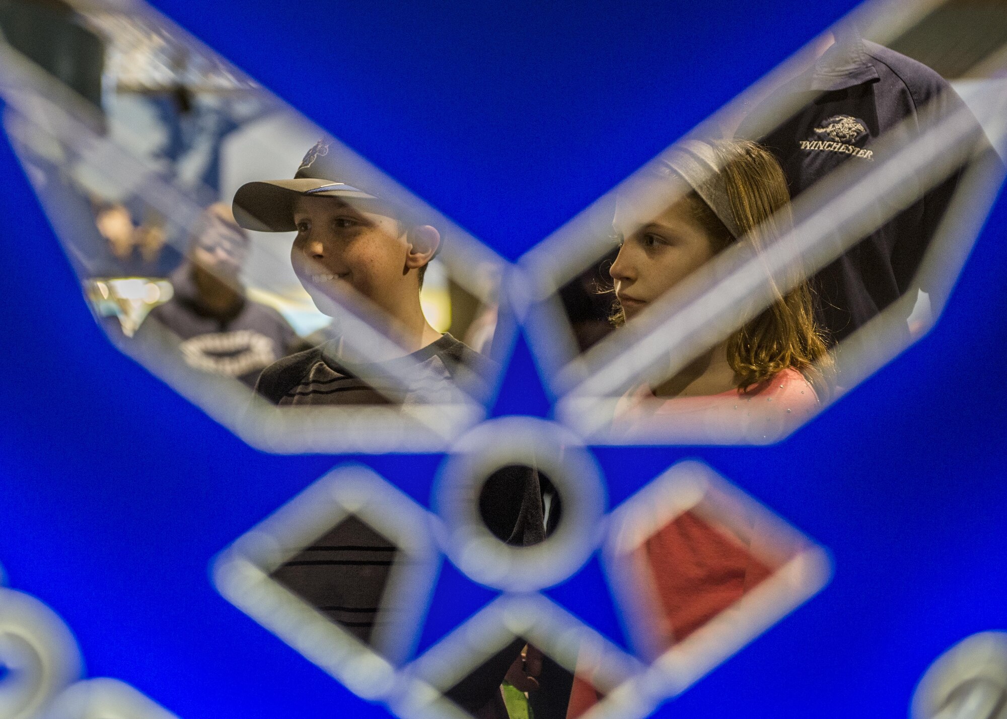 Children watch while visitors try the virtual reality experience.  (U.S. Air Force photo by Staff Sgt. Jodi Martinez)