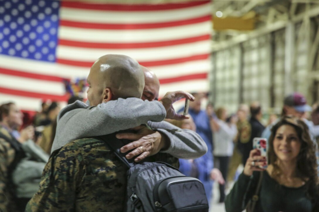 Marine Corps Sgt. Nicholas Christopoulas reunites with his family at Marine Corps Air Station Cherry Point, N.C., Jan. 17, 2017, after a seven-month deployment. Christopoulas is a fixed-wing safety equipment mechanic assigned to Marine Attack Squadron 542. Marine Corps photo by Lance Cpl. Cody Lemons