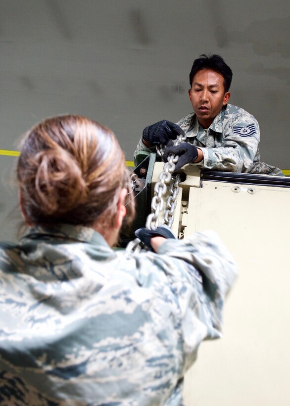 Tech. Sgt. Geofrey Erese, Eagle Vision Data Integration Segment non-commission officer-in-charge, unchains a hard-sided shelter shortly after arriving at Clark Air Base, Philippines, Jan. 14, 2017. Erese is a Hawaii Air National Guardsman deployed to the Philippines to support a Pacific Air Forces Subject Matter Expert Exchange between the U.S. and Philippine Air Forces. The SMEE focuses on the employment of a ground-based commercial satellite imaging system, called Eagle Vision, as part of Humanitarian Assistance and Disaster Relief operations. (U.S. Air Force photo by Tech. Sgt. James Stewart/Released)