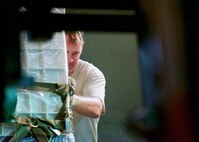 U.S. Air Force Master Sgt. Eric Martin, Eagle Vision Data Acquisition Segment non-commissioned officer-in-charge, pushes a pallet while unloading cargo after arriving at Clark Air Base, Philippines, Jan. 14, 2017. The cargo contains the components of the ground-based commercial satellite imagery system, Eagle Vision. Martin and approximately 15 other U.S. Airmen and Soldiers deployed to the Philippines to support a Pacific Air Forces Subject Matter Expert Exchange with the Philippine Air Force. The two-week long SMEE will concentrate on how Eagle Vision, and satellite imagery, can enhance the two nation's Humanitarian Assistance and Disaster Relief capabilities. (U.S. Air Force photo by Tech. Sgt. James Stewart/Released)