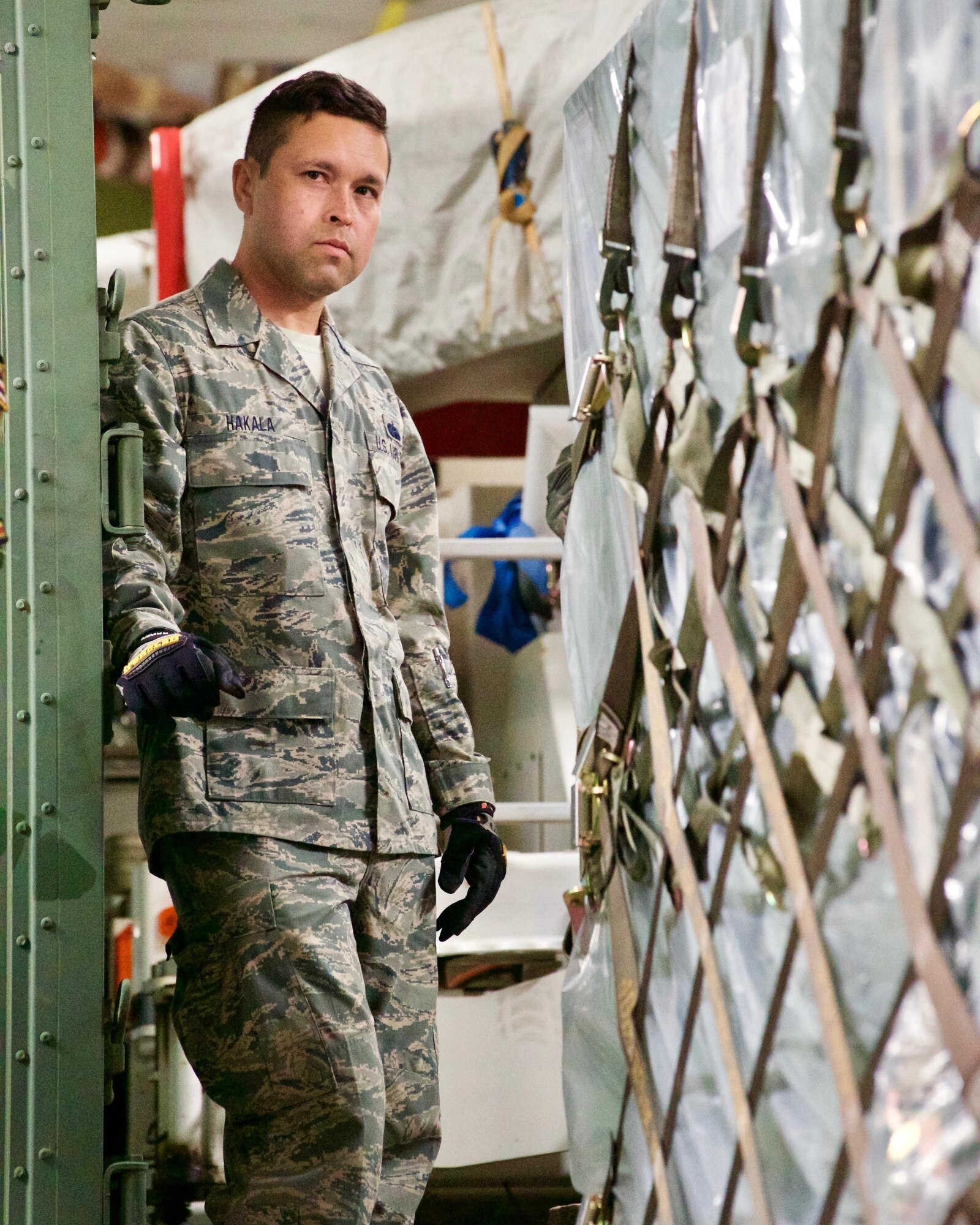 Tech. Sgt. Jesse Hakala, systems administrator, stands ready to push a pallet while unloading cargo after arriving at Clark Air Base, Philippines, Jan. 14, 2017. The cargo contains the components of ground-based commercial satellite imagery system named Eagle Vision. Hakala and approximately 15 other U.S. Airmen and Soldiers deployed to the Philippines to support a Pacific Air Forces Subject Matter Expert Exchange with the Philippine Air Force. The two-week long SMEE will concentrate on how Eagle Vision, and satellite imagery, can enhance the two nation's Humanitarian Assistance and Disaster Relief capabilities. (U.S. Air Force photo by Tech. Sgt. James Stewart/Released)
