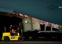 U.S. Air Force Master Sgt. Kerrie Morris, loadmaster, guides a Filipino forklift operator while unloading a C-17 Globemaster III after arriving at Clark Air Base, Philippines, Jan. 14, 2017. The aircraft transported a team of U.S. Airmen and Soldiers and a ground-based commercial satellite imagery system known as Eagle Vision. While in the Philippines, the U.S. servicemembers will share experiences with their Philippine Air Force allies in using Eagle Vision and satellite imagery as a tool for enhancing their combined Humanitarian Assistance and Disaster Relief capabilities. (U.S. Air Force photo by Tech. Sgt. James Stewart/Released)