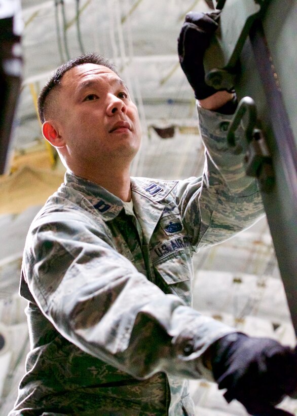 U.S. Air Force Capt. Jay Munechika, Eagle Vision 5 officer-in-charge, pushes a pallet while unloading cargo after arriving at Clark Air Base, Philippines, Jan. 14, 2017. The cargo contains the components of ground-based commercial satellite imagery system named Eagle Vision. Munechika and approximately 15 other U.S. Airmen and Soldiers deployed to the Philippines to support a Pacific Air Forces Subject Matter Expert Exchange with the Philippine Air Force. The two-week long SMEE will concentrate on how Eagle Vision, and satellite imagery, can enhance the two nation's Humanitarian Assistance and Disaster Relief capabilities. (U.S. Air Force photo by Tech. Sgt. James Stewart/Released)