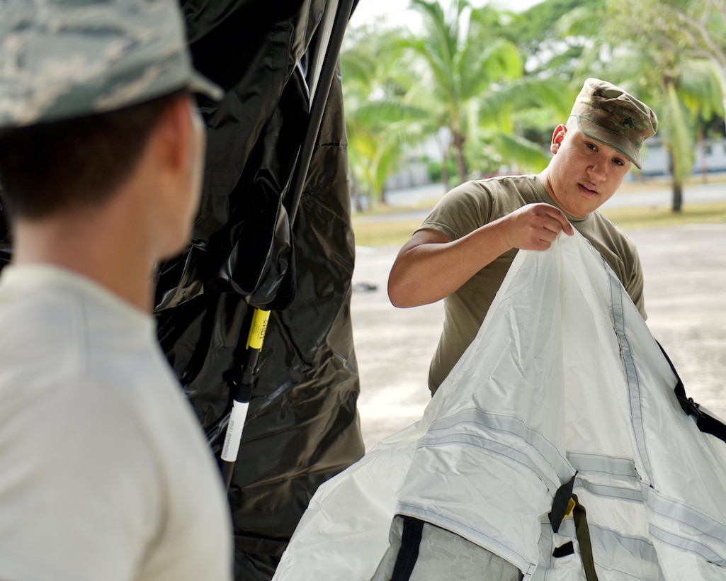 U.S. Army Sgt. Oscar Ramirez, a geospatial imagery analyst with the 500th Military Intelligence Brigade at Ft. Shafter, Hawaii, helps assemble a Base-X Shelter, Clark Air Base, Philippines, Jan. 15, 2017. Ramirez is a member of a 15-person team deployed to the Philippines to support a Pacific Air Forces Subject Matter Expert Exchange with the Philippine Air Force. The two-week long SMEE will concentrate on how Eagle Vision, and satellite imagery, can enhance the two nation's Humanitarian Assistance and Disaster Relief capabilities. (U.S. Air Force photo by Tech. Sgt. James Stewart/Released)