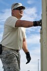U.S. Air Force Staff Sgt. Joel Fernandez, Eagle Vision Data Acquistion Segment operator with the Hawaii Air National Guard, levels an expandable, two-sided, tactical shelter's support leg while setting up the Eagle Vision work site, Clark Air Base, Philippines, Jan. 15, 2017. Fernandez is a member of a 15-person team deployed to the Philippines to support a Pacific Air Forces Subject Matter Expert Exchange with the Philippine Air Force. The team will work with Philippine Airmen to share how satellite imagery can help enhance Humanitarian Assistance and Disaster Relief efforts common in the Asia-Pacific. (U.S. Air Force photo by Tech. Sgt. James Stewart/Released)
