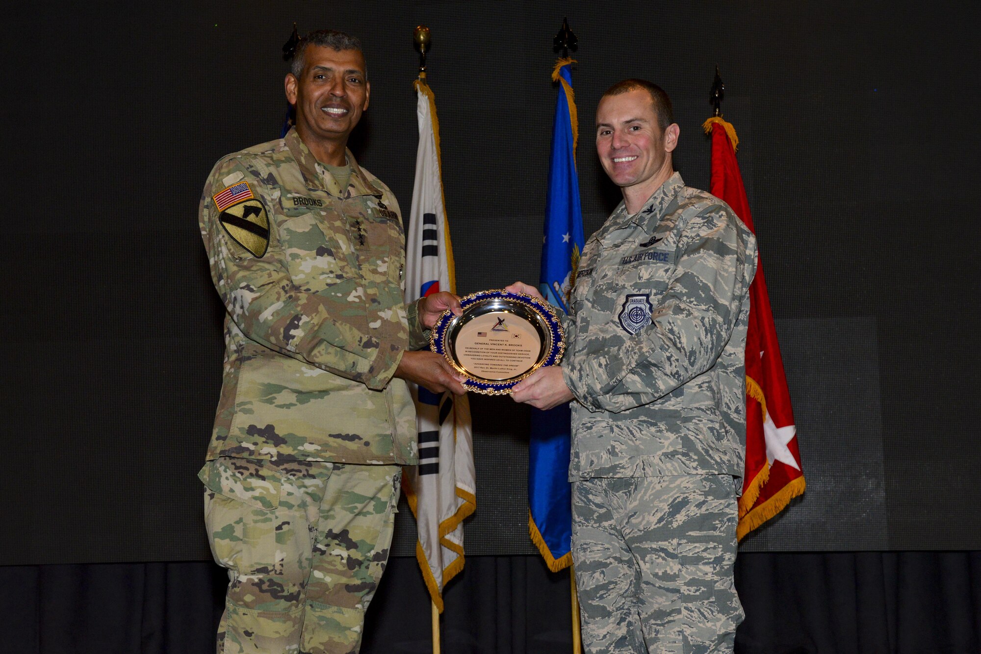 U.S. Air Force Col. Cary Culbertson, 51st Fighter Wing vice commander, presents U.S. Army Gen. Vincent K. Brookes, United States Forces Korea commander, with a token of appreciation at Osan Air Base, Republic of Korea, Jan. 16, 2017. Brooks was the keynote speaker at the Osan Martin Luther King Jr. Day memorial program and presented several members of Team Osan with awards in recognition of their contributions to making the Osan community better. (U.S. Air Force photo by Senior Airman Victor J. Caputo)
