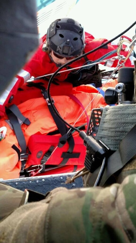 A Guardian Angel pararescueman from the 131st Rescue Squadron, guide a litter carrying a civilian patient onto an HH-60G Pave Hawk  helicopter during an over water rescue mission, Jan. 17, 2017.  California Air National guardsmen from the 129th Rescue Wing performed a personnel recovery mission of the seriously ill 14-year-old boy on board a cruise liner, the STAR PRINCESS, approximately 450 miles off the coast of San Diego, California.  (Courtesy photo by Lt. Col Kathryn Hodge/released)