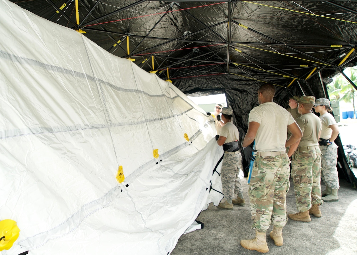 A joint team of U.S. Airmen and Soldiers attach an interior liner to a Base-X Shelter, Clark Air Base, Philippines, Jan. 15, 2017. The shelter will house an Eagle Vision Data Integration Segment. Eagle Vision is a ground-based commercial satellite imagery system. While in the Philippines, the team of U.S. service members will exchange ideas and experiences with their Philippine allies on how the Eagle Vision system can enhance Humanitarian Assistance and Disaster Relief capabilities.(U.S. Air Force photo by Tech. Sgt. James Stewart/Released)