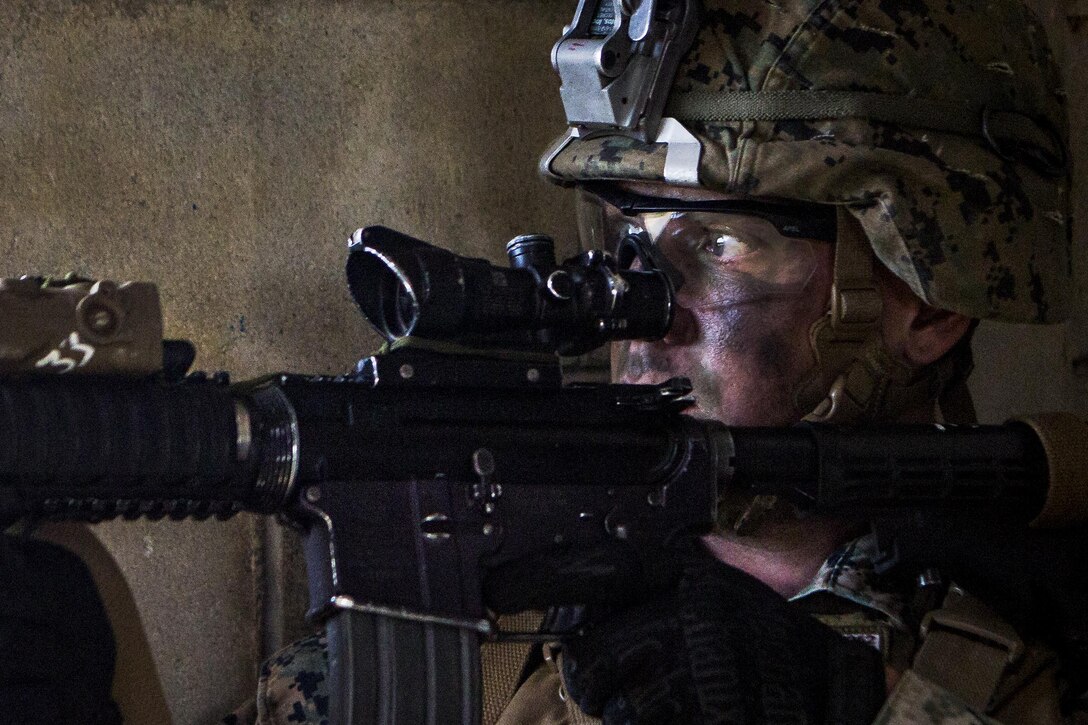 Marine Cpl. Michael Pimenidis provides security with an M4 carbine while participating in a mechanized raid as part of the Marine Expeditionary Unit Exercise at Marine Corps Base Camp Butler, Okinawa, Japan, Jan. 16, 2017. Pimenidis is a a team leader assigned to Echo Company, Battalion Landing Team, 2nd Battalion, 5th Marine Regiment, 31st Marine Expeditionary Unit. The exercise integrates aviation, ground and logistics elements to build the interoperability between the components of the Marine Air-Ground Task Force. Marine Corps photo by Cpl. Darien J. Bjorndal