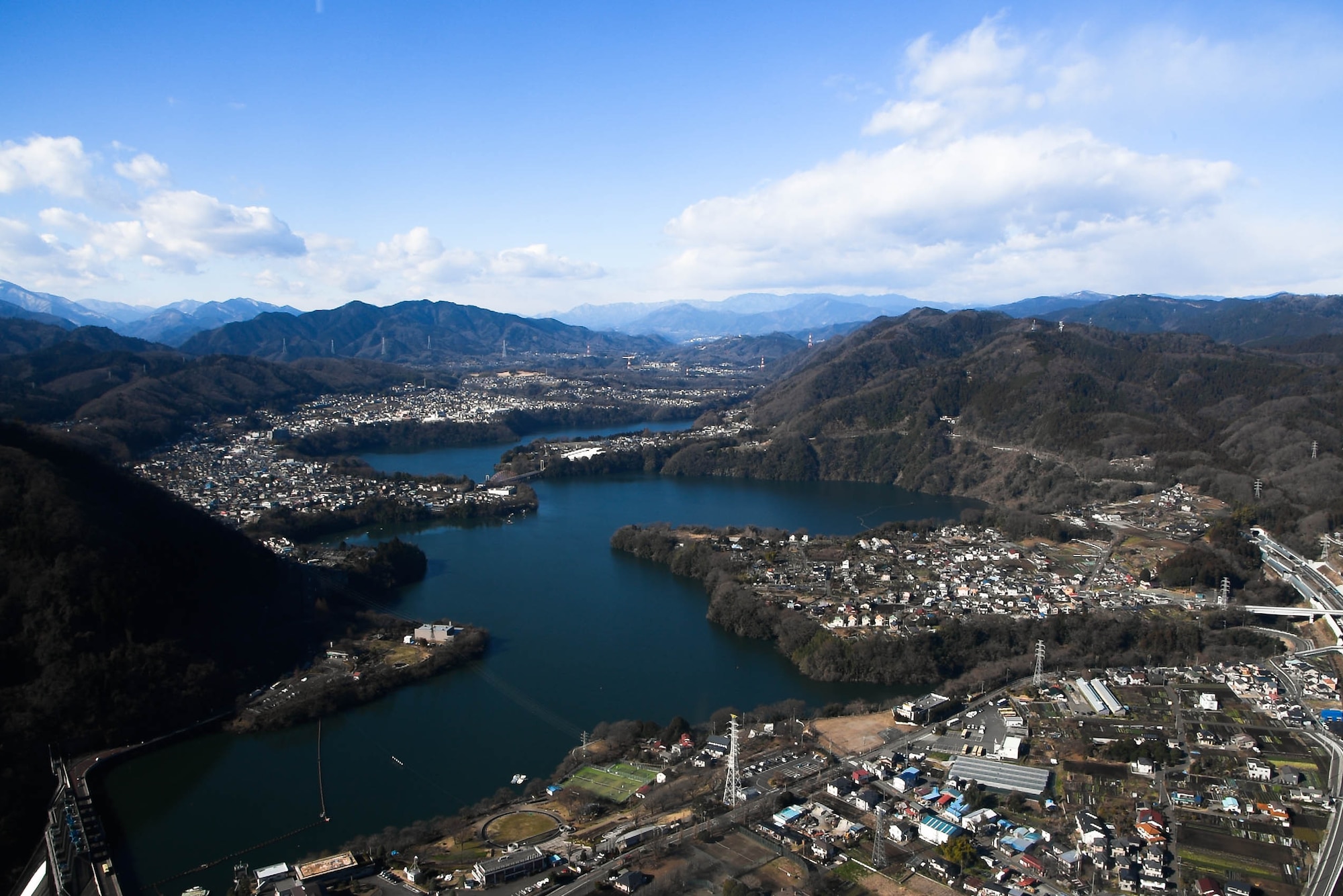 The view from the inside of a UH-1N Iroquois as it flies over a lake near Mt. Fuji, Japan, during a training mission Jan. 13, 2017. Members of the 459th Airlift Squadron complete hoist training at a landing zone near Mt. Fuji. (U.S. Air Force photo by Staff Sgt. David Owsianka)