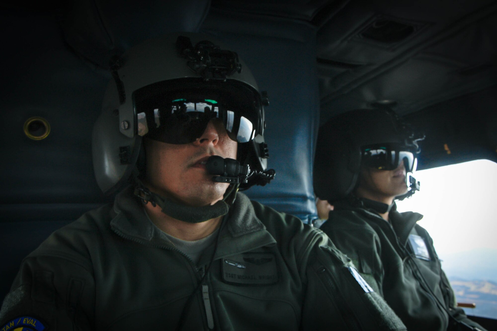 Tech. Sgt. Michael Wright, 459th Airlift Squadron special mission aviator evaluator, left, and Lt. Col. Valerie Johnson, 374th Medical Group aerospace medicine chief, sit in a UH-1N Iroquois during a training mission flying over the Kanto Plains, Japan, Jan. 13, 2017. During the scenario, the aircrew performed an alternate insertion of crew members, hoist insertion and extraction from 25-35 feet above ground, and proper landing and takeoff techniques throughout various landing zones. (U.S. Air Force photo by Staff Sgt. David Owsianka)