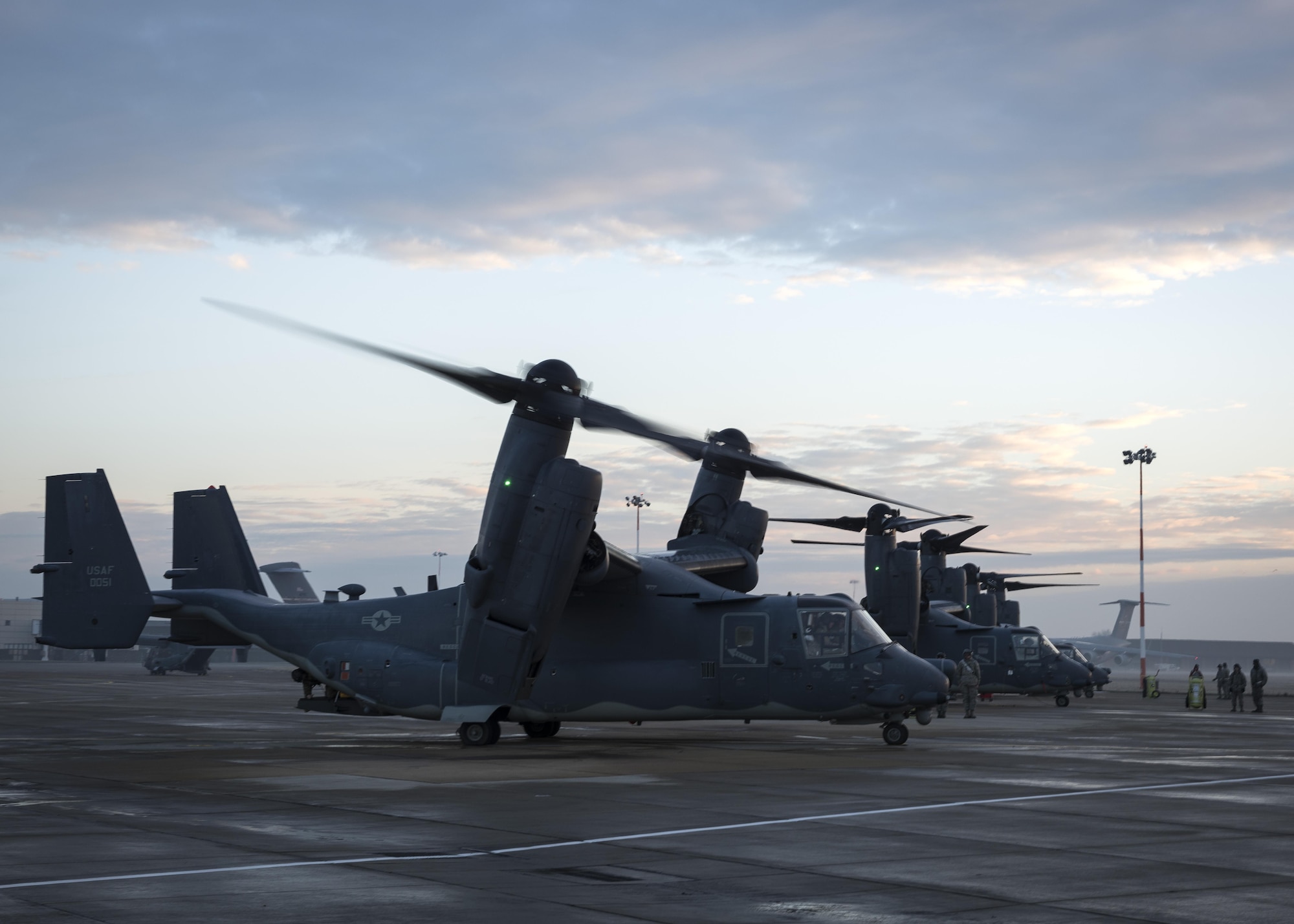 A CV-22 Osprey, assigned to the 352d Special Operations Wing taxis past Airmen from the 352d Special Operations Maintenance Squadron prior to takeoff Jan. 17, 2017 on RAF Mildenhall, England. From the flightline to the cockpit, a combination of dedicated Airmen keep these CV-22s capable of supporting global special operations forces at a moment’s notice. (U.S. Air Force photo by 1st Lt Chris Sullivan)