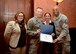 Maggie Laws, 31st Fighter Wing Community Support coordinator, Air Force Brig. Gen. Lance Landrum, 31st FW commander and retired Army Brig. Gen. (Dr.) Rhonda Cornum, first director of the Army’s Comprehensive Soldier Fitness initiative, present a certificate to Air Force Master Sgt. Jason Rollins, 31st Operations Support Squadron assistant chief controller, tower, at Aviano Air Base, Italy on Jan. 9, 2017. Rollins was presented the certificate for earning the title of Master Resilience Trainer of the Year for 2016. (U.S. Air Force photo by Senior Airman Areca T. Bell)
