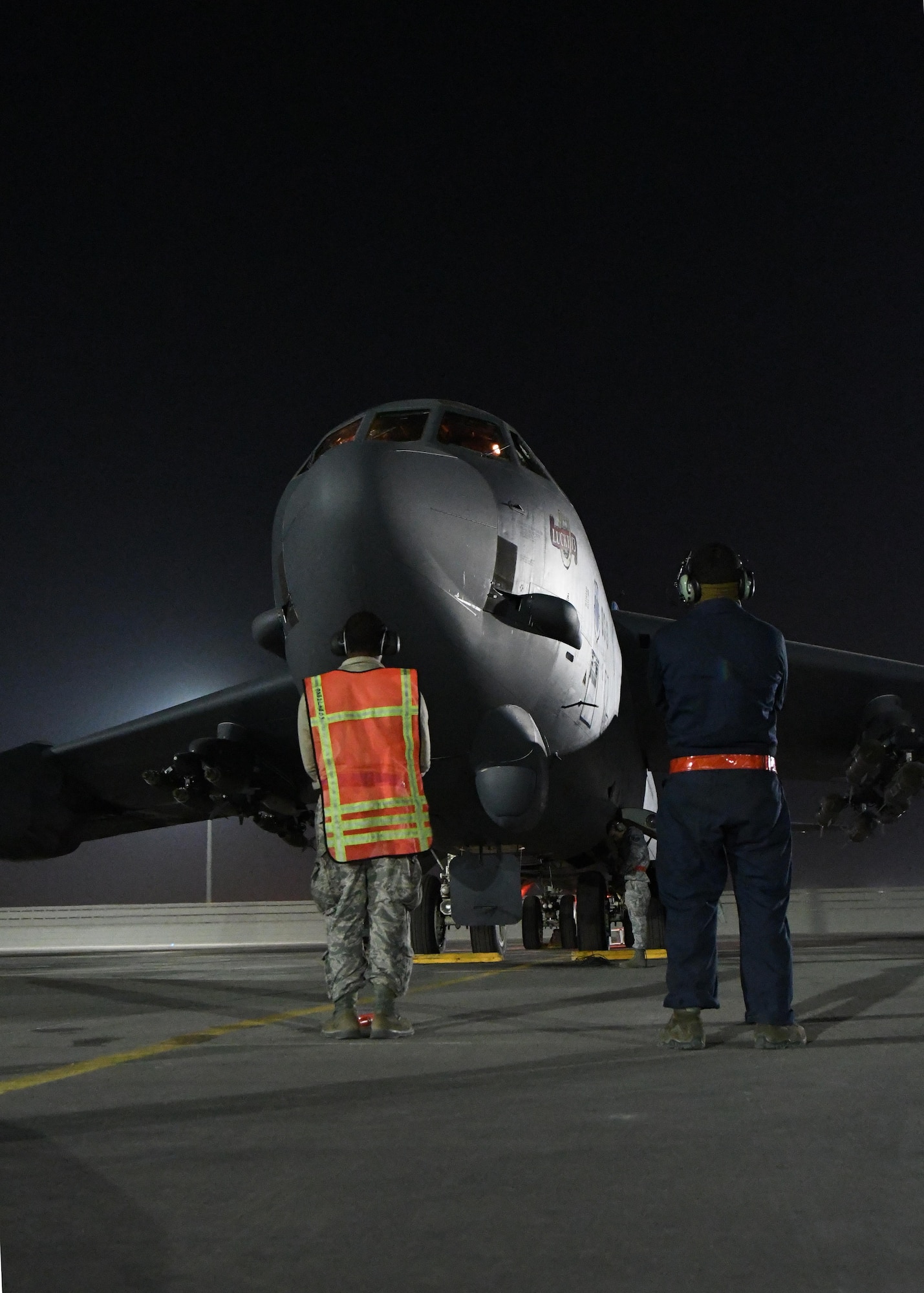 Airmen from the 96th Expeditionary Aircraft Maintenance Unit wait to marshal a B-52 Stratofortress prior to takeoff from an undisclosed location in Southwest Asia, Jan. 4, 2017. In a conventional conflict, the B-52 can perform strategic attack, air interdiction, offensive counter-air and maritime operations.  (U.S. Air Force photo by Senior Airman Miles Wilson)