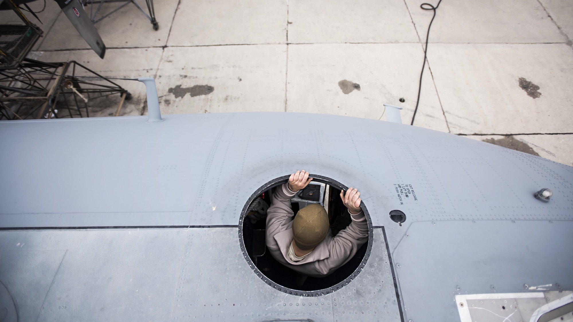 Staff Sgt. Sean Nelson, 455th Expeditionary Aircraft Maintenance Squadron crew chief, lowers himself off the roof of an EC-130 Compass Call Jan. 18, 2017 at Bagram Airfield, Afghanistan. The aircraft’s communications jamming capability is an indispensable asset to ground forces and has led to 2,193 terrorists removed from the battlefield, just since 2014. (U.S. Air Force photo by Staff Sgt. Katherine Spessa)
