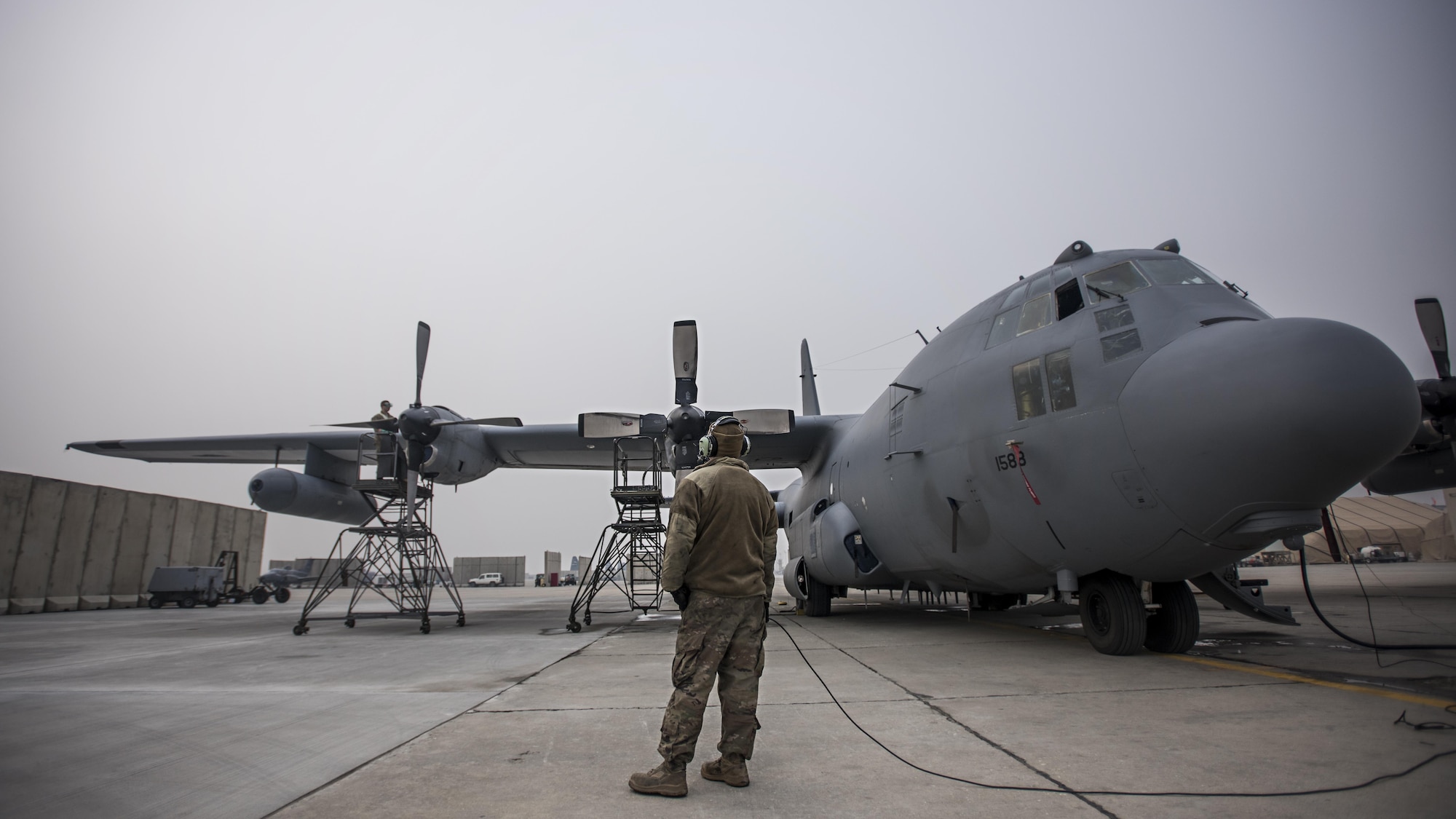 Staff Sgt. Kyle Poston, 455th Expeditionary Aircraft Maintenance Squadron crew chief, oversees engine maintenance on an EC-130 Compass Call Jan. 18, 2017 at Bagram Airfield, Afghanistan. To date, 41st EECS crews have flown over 39,000 hours during 6,800 combat sorties in support of Operation Enduring Freedom, and now the Resolute Support Mission. (U.S. Air Force photo by Staff Sgt. Katherine Spessa)