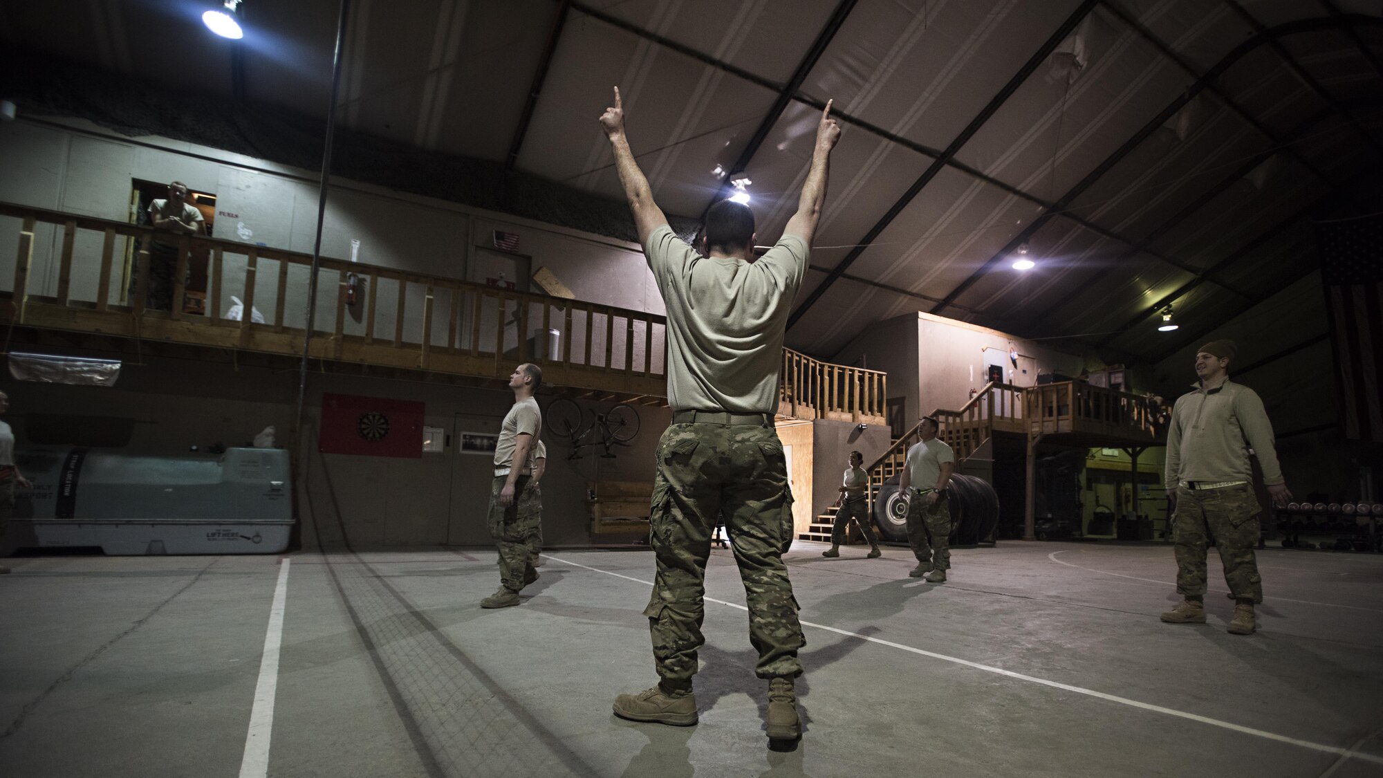 Senior Master Sgt. Scott Conner, 455th Expeditionary Aircraft Maintenance Squadron C-130 Compass Call Aircraft Maintenance Unit superintendent, cheers after his team scored in a volleyball game at Bagram Airfield, Afghanistan Jan. 12, 2017. Individuals throughout the AMU often have deployments in the double digits, with months out of each year spent away from home. (U.S. Air Force photo by Staff Sgt. Katherine Spessa)