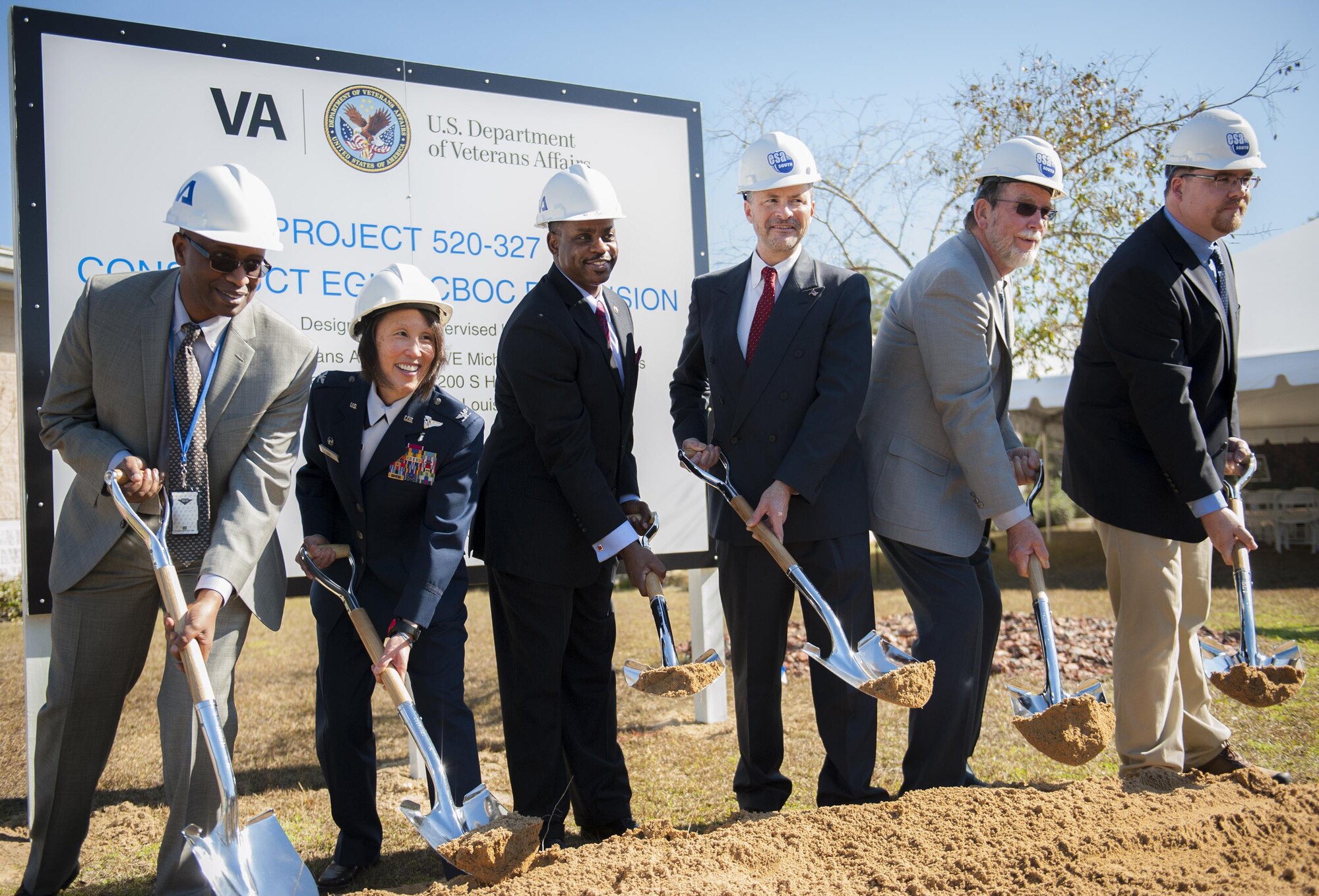 Project leaders throw first shovels of dirt on Jan. 13 to break ground at the Department of Veterans' clinic expansion project.  (U.S. Air Force photo/Sara Francis)