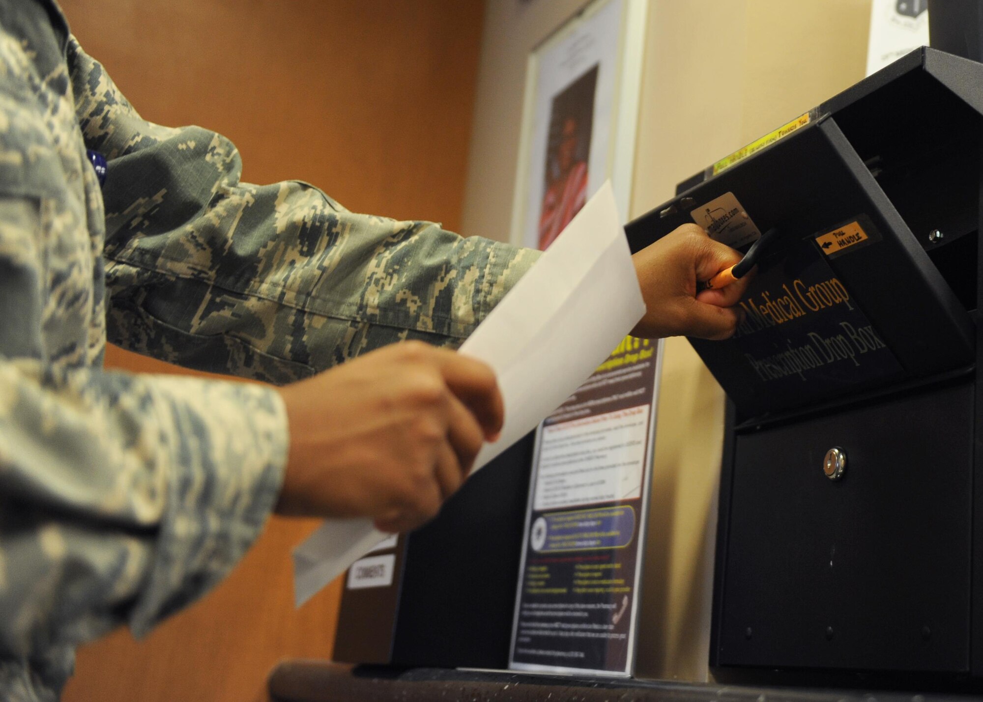 A service member uses the prescription drop box Jan. 12, 2017, at the 19th Medical Group pharmacy on Little Rock Air Force Base, Ark. The drop box is available 7:30 a.m. to 4:30 p.m. Monday through Friday in the pharmacy lobby. (U.S. Air Force photo by Airman 1st Class Grace Nichols)