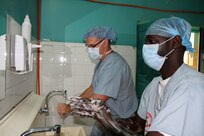 U.S. Army Reserve nurse anesthetist Lt. Col. Edward Alexander, from the 332nd Medical Brigade in Nashville, Tenn., and a Senegalese biomedical technician, wash their hands prior to providing anesthetics for a leg realignment surgery during Medical Readiness Training Exercise 17-1 at Hospital Militaire De Ouakam in Dakar, Senegal, Jan. 17, 2017. MEDRETE is a combined effort between the Senegalese government, U.S. Army Africa, the U.S. Army Reserve 332nd Medical Brigade in Nashville, Tenn., and the Vermont Air National Guard. MEDRETE 17-1 is the first in a series of medical readiness training exercises that U.S. Army Africa is scheduled to facilitate within various countries in Africa, and serves as an opportunity for the partnered militaries to hone and strengthen their general surgery and trauma skills while reinforcing the partnership between the countries. The mutually beneficial exercise brings together Senegalese military and U.S. Army medical professionals to foster cooperation while conducting medical specific tasks. 