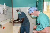 Senegalese surgeon Boubacar Mbaye and Vermont Air National Guard surgeon Maj. Anthony Donaldson wash their hands prior to conducting leg realignment surgery during Medical Readiness Training Exercise 17-1 at Hospital Militaire De Ouakam in Dakar, Senegal, Jan. 17, 2017. MEDRETE is a combined effort between the Senegalese government, U.S. Army Africa, the U.S. Army Reserve 332nd Medical Brigade in Nashville, Tenn., and the Vermont Air National Guard. MEDRETE 17-1 is the first in a series of medical readiness training exercises that U.S. Army Africa is scheduled to facilitate within various countries in Africa, and serves as an opportunity for the partnered militaries to hone and strengthen their general surgery and trauma skills while reinforcing the partnership between the countries. The mutually beneficial exercise brings together Senegalese military and U.S. Army medical professionals to foster cooperation while conducting medical specific tasks. 