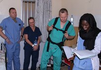 Vermont Air National Guard flight surgeon Maj. Thomas Sterling looks at Lt. Rokhaya Niasse, a Senegalese emergency medicine doctor's, notes in the emergency room during Medical Readiness Training Exercise 17-1 at Hospital Militaire De Ouakam in Dakar, Senegal, Jan. 18, 2017. MEDRETE is a combined effort between the Senegalese government, U.S. Army Africa, the U.S. Army Reserve 332nd Medical Brigade in Nashville, Tenn., and the Vermont Air National Guard. MEDRETE 17-1 is the first in a series of medical readiness training exercises that U.S. Army Africa is scheduled to facilitate within various countries in Africa, and serves as an opportunity for the partnered militaries to hone and strengthen their general surgery and trauma skills while reinforcing the partnership between the countries. The mutually beneficial exercise brings together Senegalese military and U.S. Army medical professionals to foster cooperation while conducting medical specific tasks. 