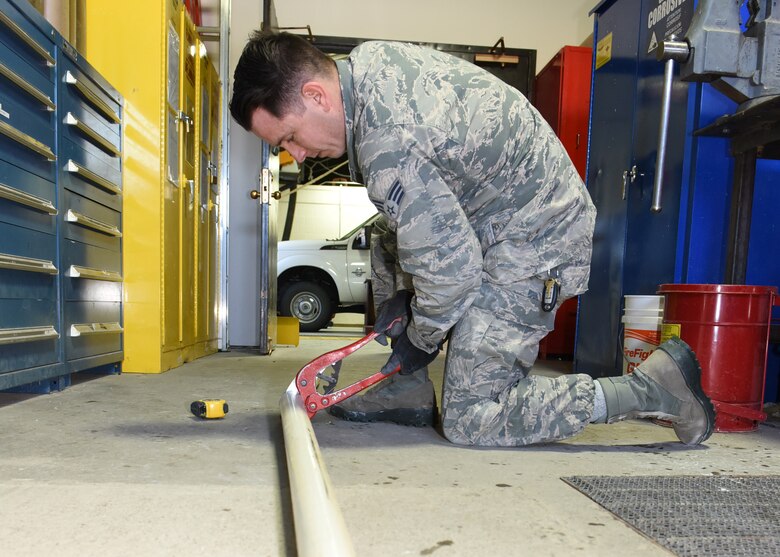 Senior Airman Verick McCorkell, 819th RED HORSE Squadron water and fuel system maintenance craftsman, cuts a piece of pipe as he installs a plumping system in a new restroom being built in Building 1450, Jan. 18, 2017, at Malmstrom Air Force Base, Mont.  McCorkell, along other Airmen assigned to the unit, are currently conducting a renovation project on their own building.  The 819th RHS is a 400-plus mobile squadron providing rapid response and independent operations through civil engineering in remote places anywhere in the world.  (U.S. Air Force photo/Jason Heavner)