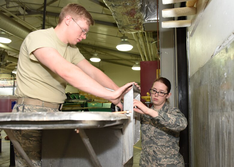 Staff Sgt. Mason Quimby, left, and Airman 1st Class Kristin Borah, both from the 819th RED HORSE Squadron, conduct preventive maintenance on a deep sink as part of a renovation project being conducted by the unit Jan. 18, 2017, at Malmstrom Air Force Base, Mont.  The 819th RHS is a 400-plus mobile squadron providing rapid response and independent operations through civil engineering in remote places anywhere in the world. (U.S. Air Force photo/Jason Heavner)