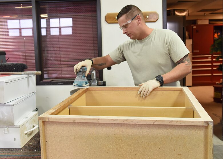 Staff Sgt. Jeremiah Oswald, 819th RED HORSE Squadron structural journeyman, sands down a wooden cabinet that will go into a newly-constructed workspace as part of a renovation project in one of the unit’s buildings Jan. 18, 2017, at Malmstrom Air Force Base, Mont.  The 819th RHS is a 400-plus mobile squadron providing rapid response and independent operations through civil engineering in remote places anywhere in the world. (U.S. Air Force photo/Jason Heavner)