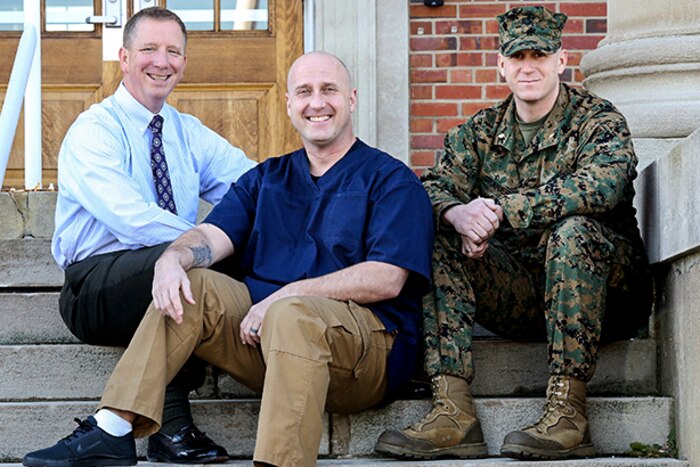 Joseph Klocek, left, and Maj. Scott Graniero, right, pose with Marine Corps Master Sgt. Clifford Farmer at Marine Corps Systems Command at Marine Corps Base Quantico, Va., Dec. 20, 2016. Farmer credits the support and compassion of the two men -- part of his leadership team at MCSC -- with saving his life during a time when he contemplated suicide. Farmer, who today battles post-traumatic stress disorder and depression, urges leaders across the Marine Corps to show understanding and compassion for Marines who may be suffering. Marine Corps photo by Monique Randolph