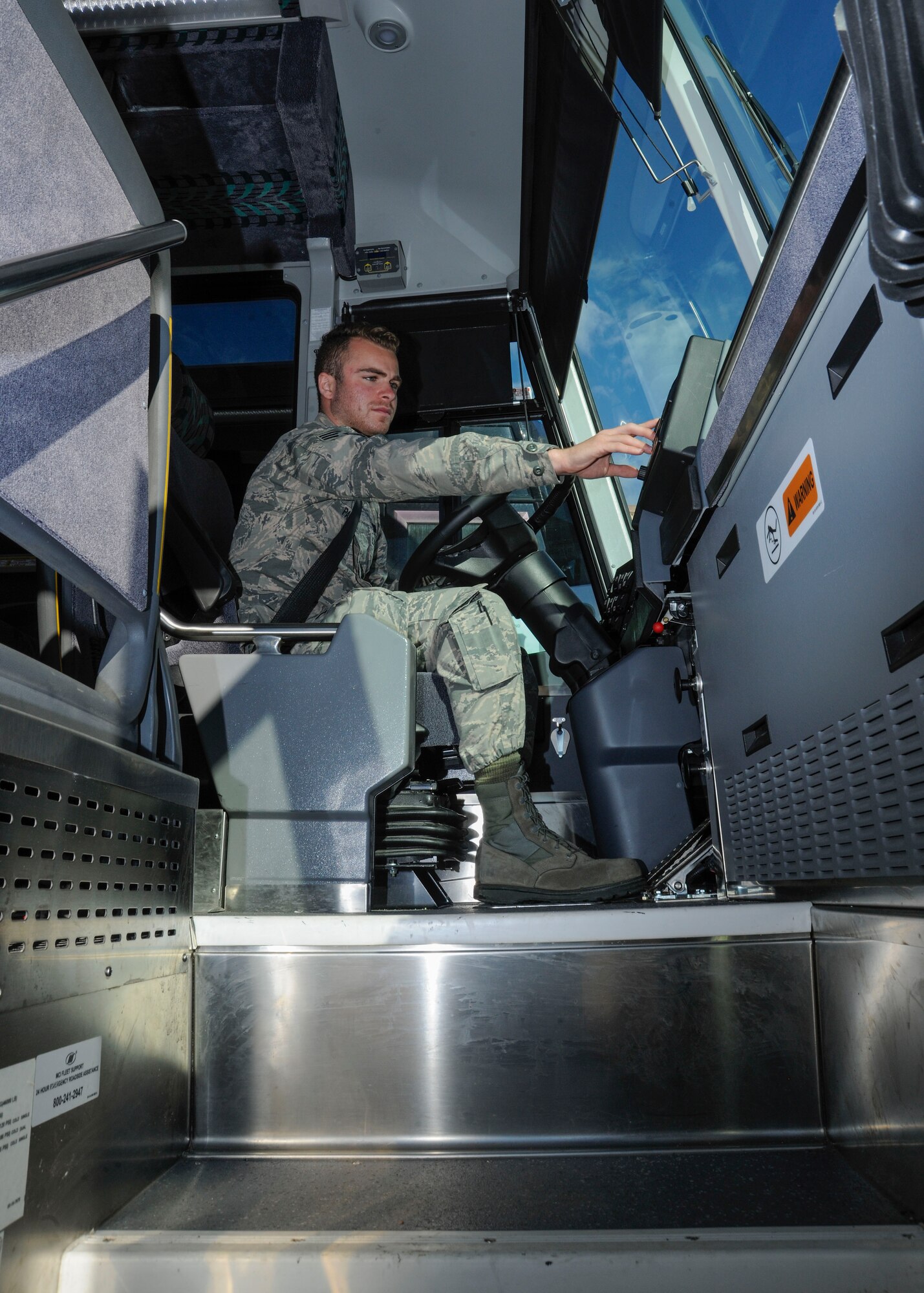 Senior Airman Josiah Parkas, 11th Logistics Readiness Squadron vehicle dispatcher, performs function checks on a bus that will be used in support of the 58th Presidential Inauguration, at Joint Base Andrews, Md., Jan. 18, 2017.  LRS will transport approximately 1500 passengers from the National Capital Region to Washington D.C. so they can take part in the inauguration. (U.S. Air Force photo by Staff Sgt. Stephanie Morris)