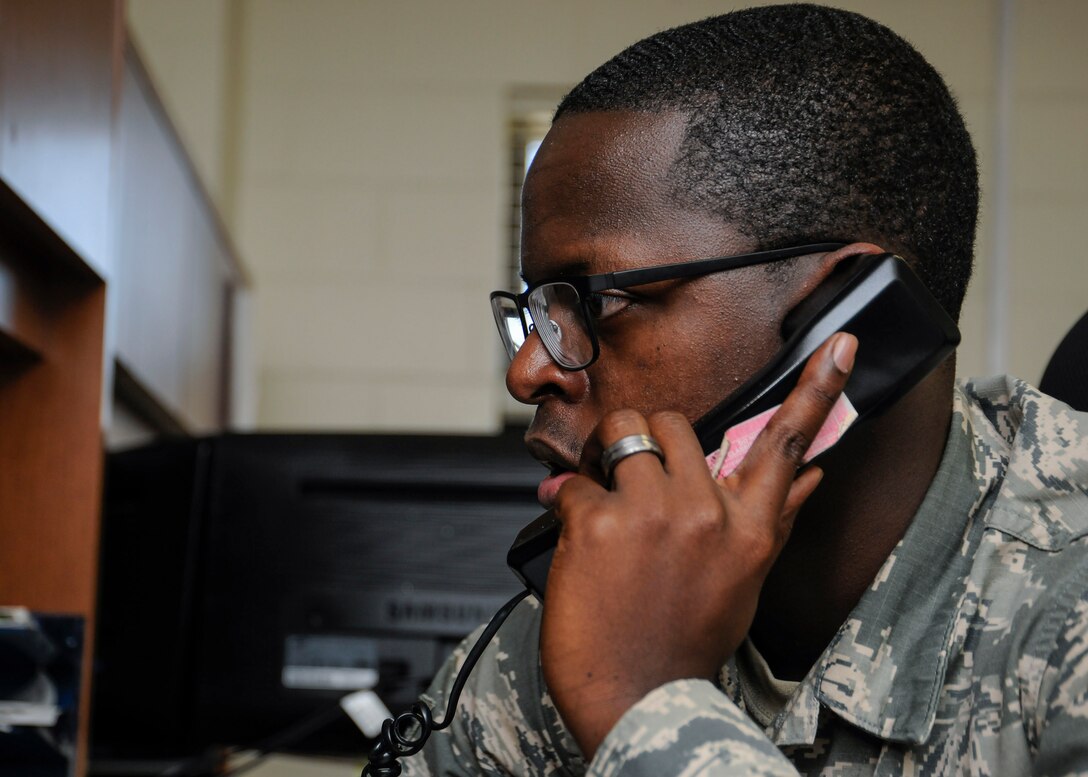 Senior Airman Eric Mitchell, 11th Logistics Readiness Squadron fleet management and analysis journeyman, answers a phone at Joint Base Andrews, Md., Jan. 18, 2017. LRS is currently preparing for the 58th Presidential Inauguration and will be mobilizing approximately 60 Airmen and eight coach buses to transport personnel to and from the event. (U.S. Air Force photo by Staff Sgt. Stephanie Morris)