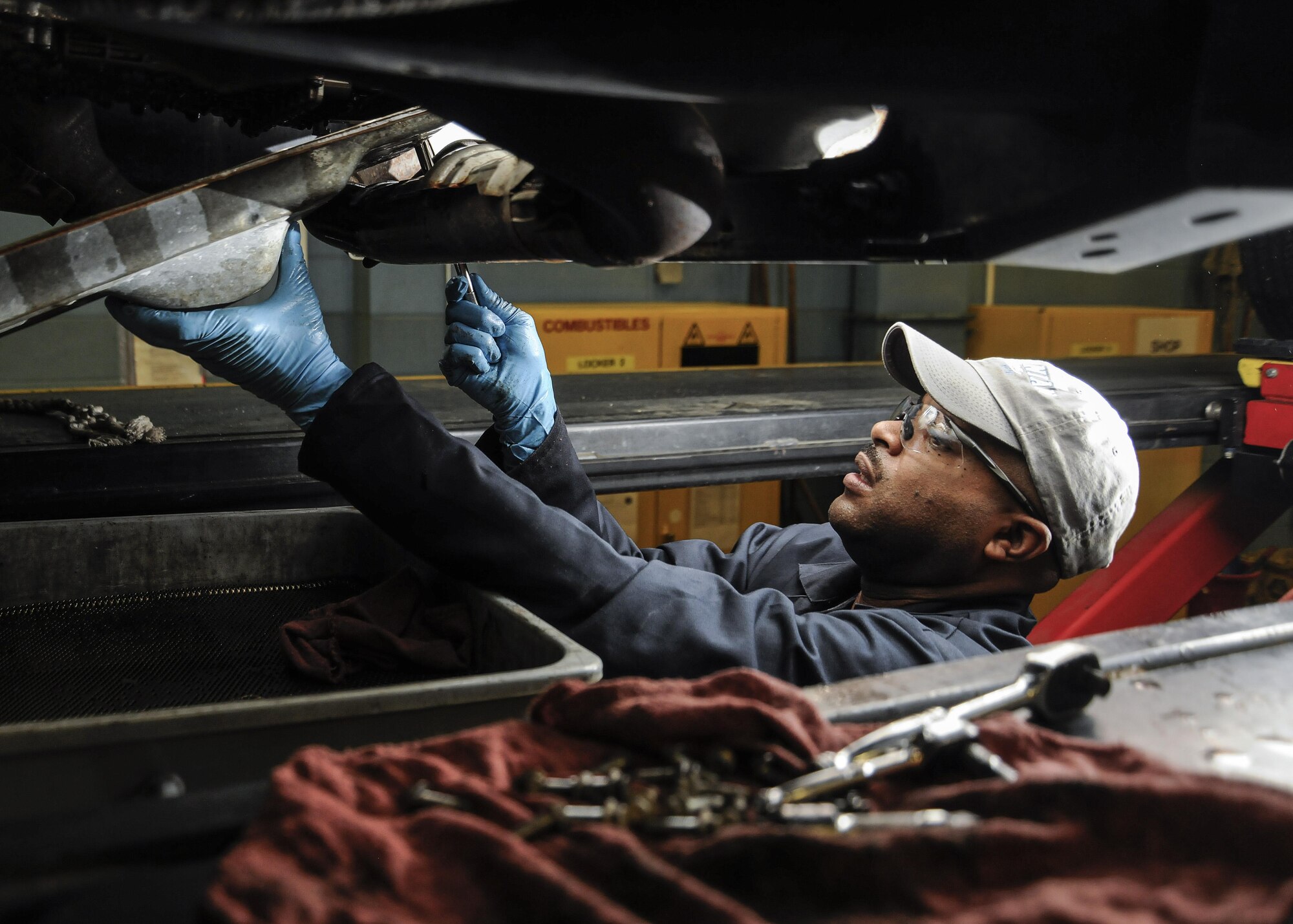 Derik Weddington, 11th Logistics Readiness Squadron automotive technician, drains transmission fluid from a vehicle on Joint Base Andrews, Md., Jan. 18, 2017. LRS is currently preparing for the 58th Presidential Inauguration and will be mobilizing approximately 60 Airmen and eight coach buses to transport personnel to and from the event. (U.S. Air Force photo by Staff Sgt. Stephanie Morris)