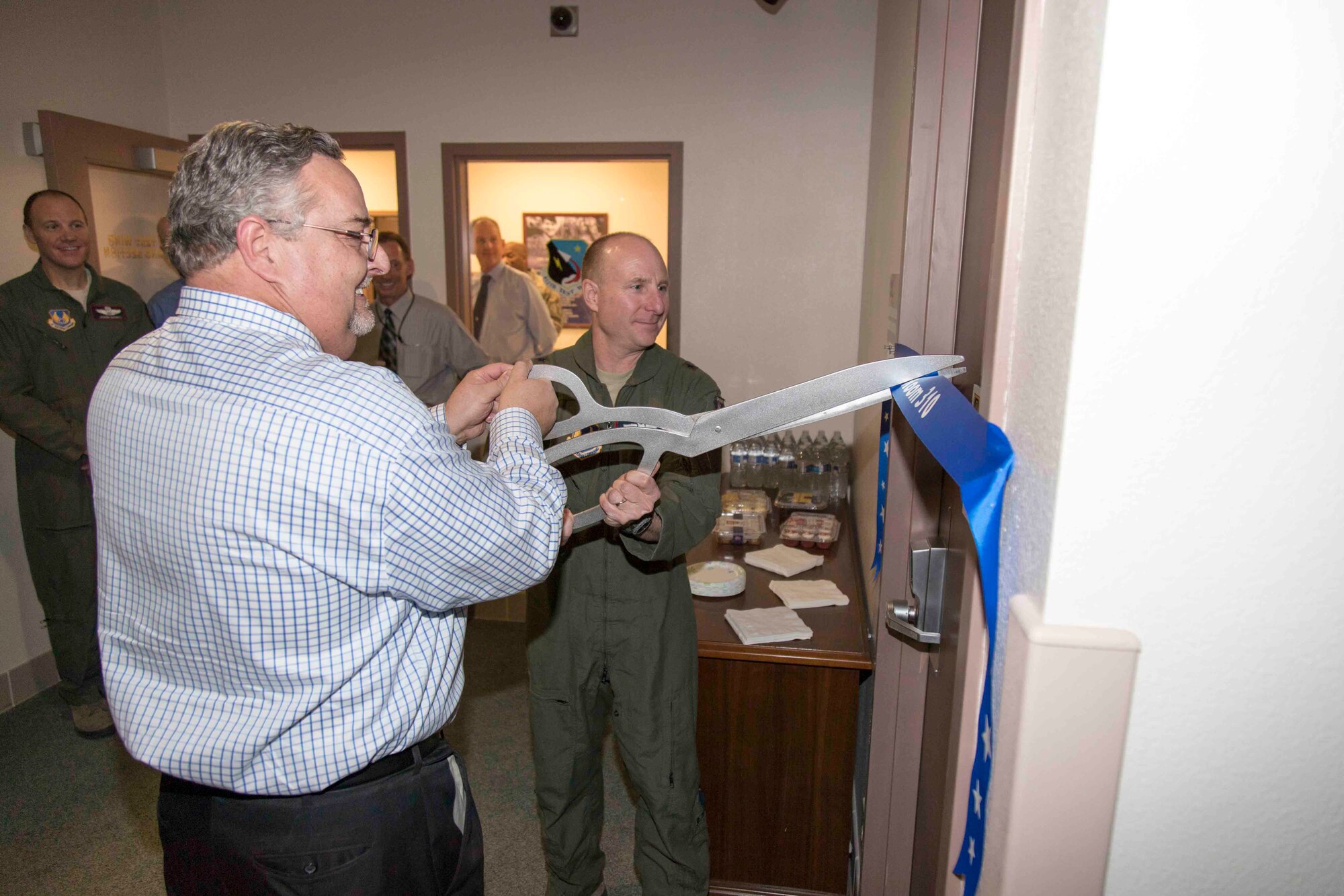 Larry Wolford (left), 412th Test Wing Experimental Center for Ideas/Technology Exploration member, and Brig. Gen. Carl Schaefer, 412th TW commander, cut the ribbon to the newly renovated conference room in Bldg. 2750 Jan. 12. (U.S. Air Force photo by Christian Turner)