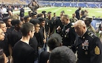 Maj. Gen. Jeffrey Snow and Command Sgt. Maj. Anthony Stoneburg, the U.S. Army Recruiting Command’s commanding general and command sergeant major, respectively, talk to local San Antonio recruits after their swearing-in ceremony during the pre-game activities at the U.S. Army All-American Bowl at the Alamodome in downtown San Antonio Jan. 7. 
