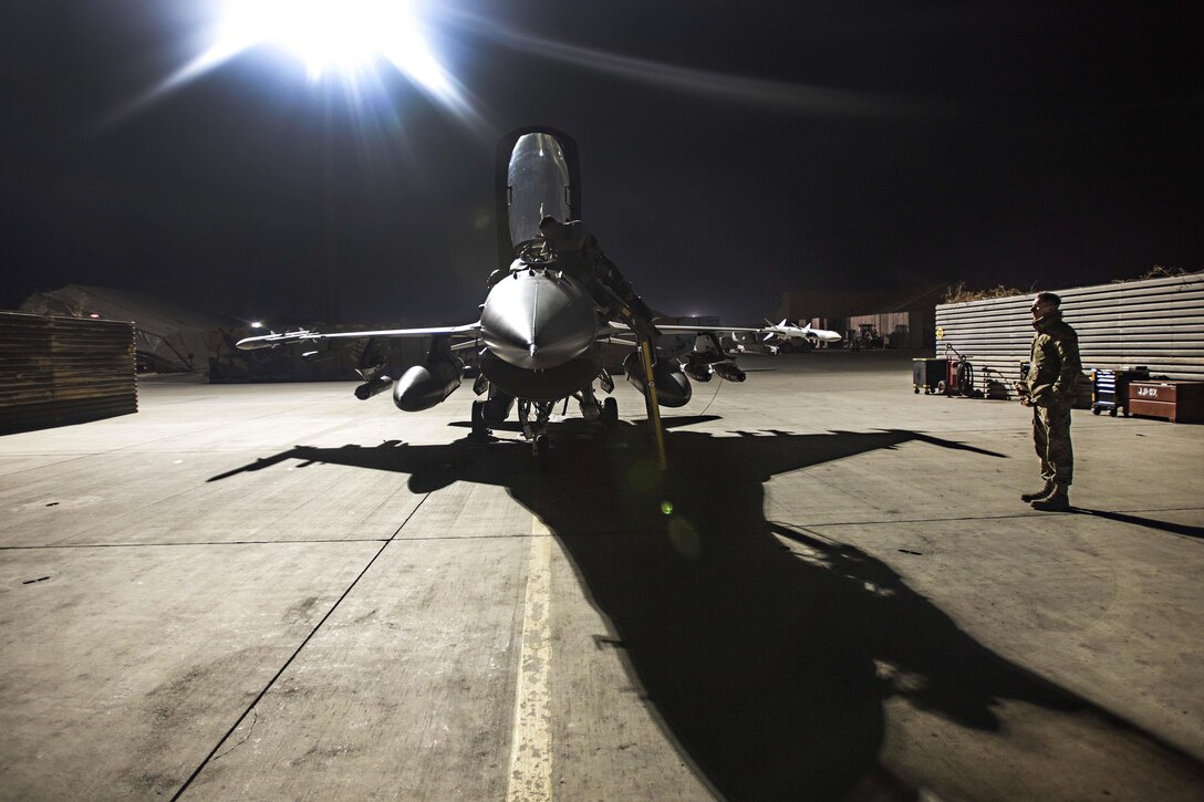 Air Force Capt. David, left, and Staff Sgt. Daniel Lasal prepare an F-16 Fighting Falcon aircraft for a night mission at Bagram Airfield, Afghanistan, Jan. 13, 2017. David is a pilot assigned to the 79th Expeditionary Fighter Squadron. Lasal is a crew chief assigned to the 455th Expeditionary Aircraft Maintenance Squadron. Air Force photo by Staff Sgt. Katherine Spessa