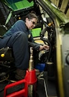Kim Smith, 54th Helicopter Squadron UH-N1 Iroquois mechanic, organizes and labels wires in the cockpit of a UH-1N Iroquois at Minot Air Force Base, N.D., Jan. 18, 2017.  The tools Smith needed for this job included wire strippers and cutters, electrical tape, a flashlight, a heat gun and wire joiners. (U.S. Air Force photo/Airman 1st Class J.T. Armstrong)