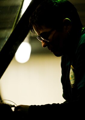 Kim Smith, 54th Helicopter Squadron UH-N1 Iroquois mechanic, organizes and labels wires in the cockpit of a UH-1N Iroquois at Minot Air Force Base, N.D., Jan. 18, 2017.  The tools Smith needed for this job included wire strippers and cutters, electrical tape, a flashlight, a heat gun and wire joiners. (U.S. Air Force photo/Airman 1st Class J.T. Armstrong)