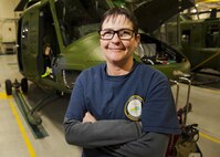 Kim Smith, 54th Helicopter Squadron UH-1N Iroquois mechanic, stands in front of a helicopter at Minot Air Force Base, N.D., Jan. 18, 2017. Smith, along with the entire 54th HS mechanic team, are civilians with prior military service. (U.S. Air Force photo/Airman 1st Class J.T. Armstrong)